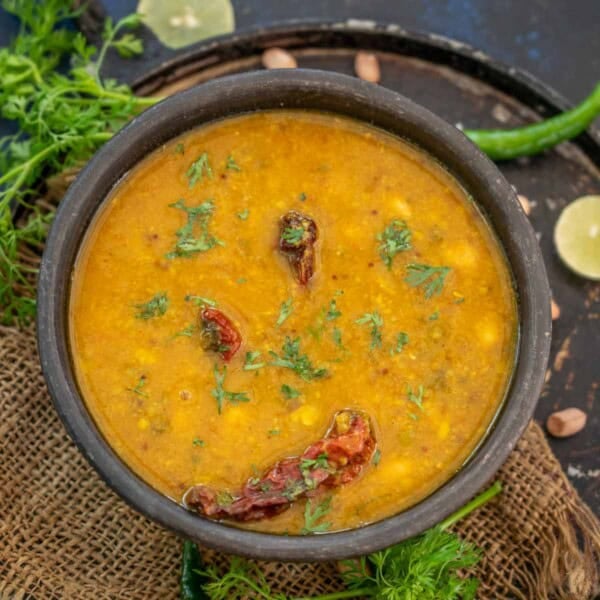 Sweet, tangy, and spicy, Gujarati Dal is comfort food at its best. Use my easy recipe to make it.