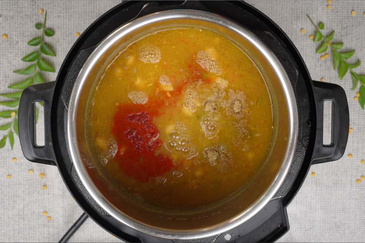 Coriander powder, red chili powder, jaggery and lime juice added to the cooked dal. Some more water also added.