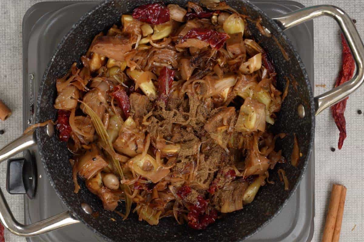 Garam masala powder added to the pan.