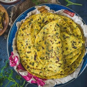 Methi Thepla is a very popular Gujarati dish made with whole wheat flour, chickpea flour, spices and fresh fenugreek leaves.