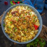 This restaurant style Mushroom Biryani is a homemade dum style veg version of Biryani. Make it at home using my recipe.