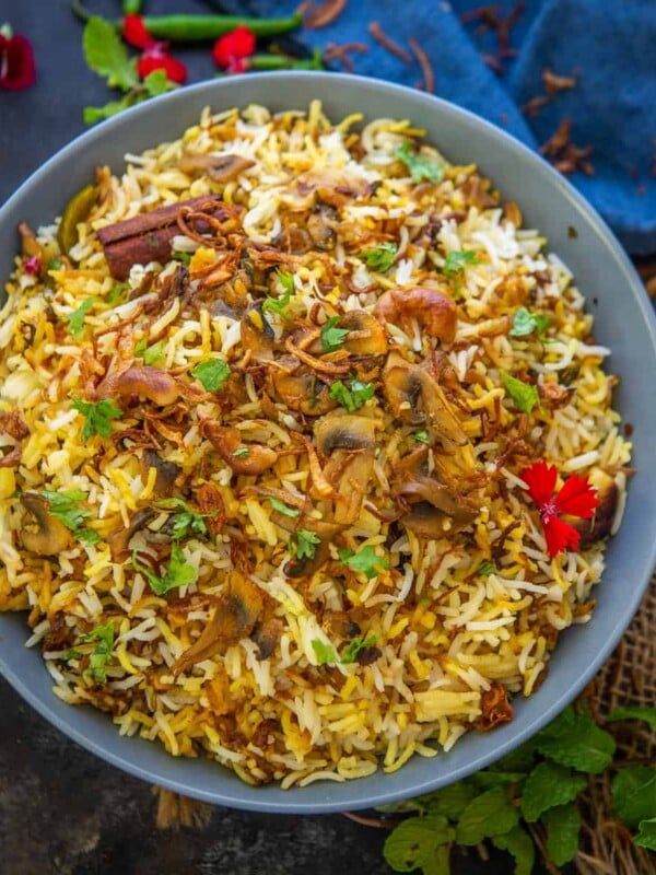This restaurant style Mushroom Biryani is a homemade dum style veg version of Biryani. Make it at home using my recipe.