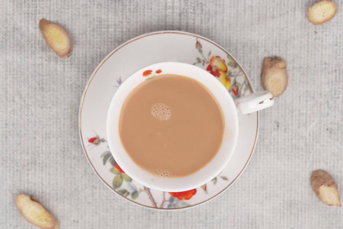 Ready ginger milk tea strained in a serving cup.