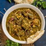 Saag gosht served on a plate.