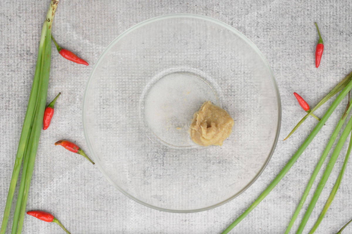 Ginger garlic paste, rice vinegar, baking soda and salt added to a bowl.