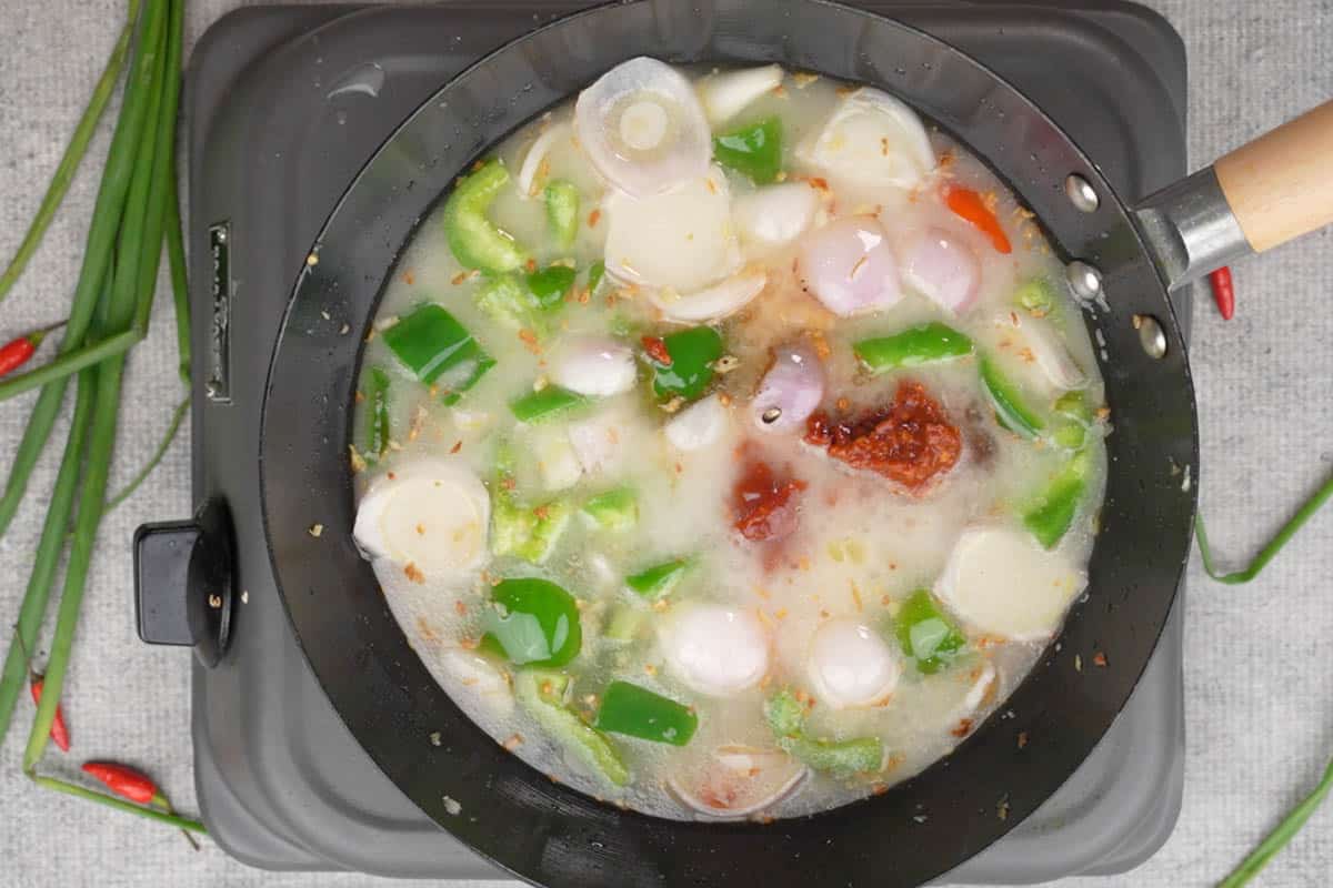 Chili paste, soy sauce and ketchup added to the wok.