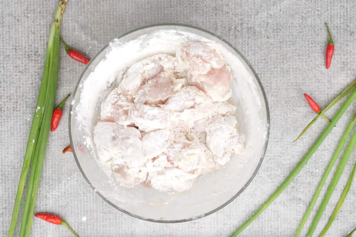 Chicken mixed with the dry ingredients.
