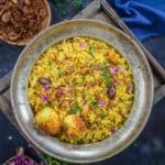 Egg Biryani or Anda Biryani  is a flavorful and delicious Indian rice preparation where rice is cooked with a spicy egg layer. It is a take on Hyderabadi Gosht Biryani and is super easy to make at home. Here is how to make egg biryani recipe at home.