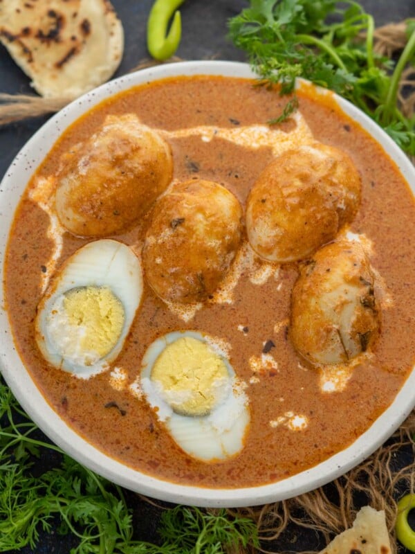 Egg Butter Masala (Egg Makhani) is rich and creamy curry, where fried hard-boiled eggs are simmered in a buttery tomato-based gravy. Here is how to make it.