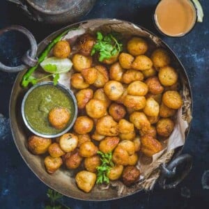 Mangalore Bonda or Goli baje are crispy, fried snacks that are firm on the outside and soft, melt-in-the-mouth on the inside.
