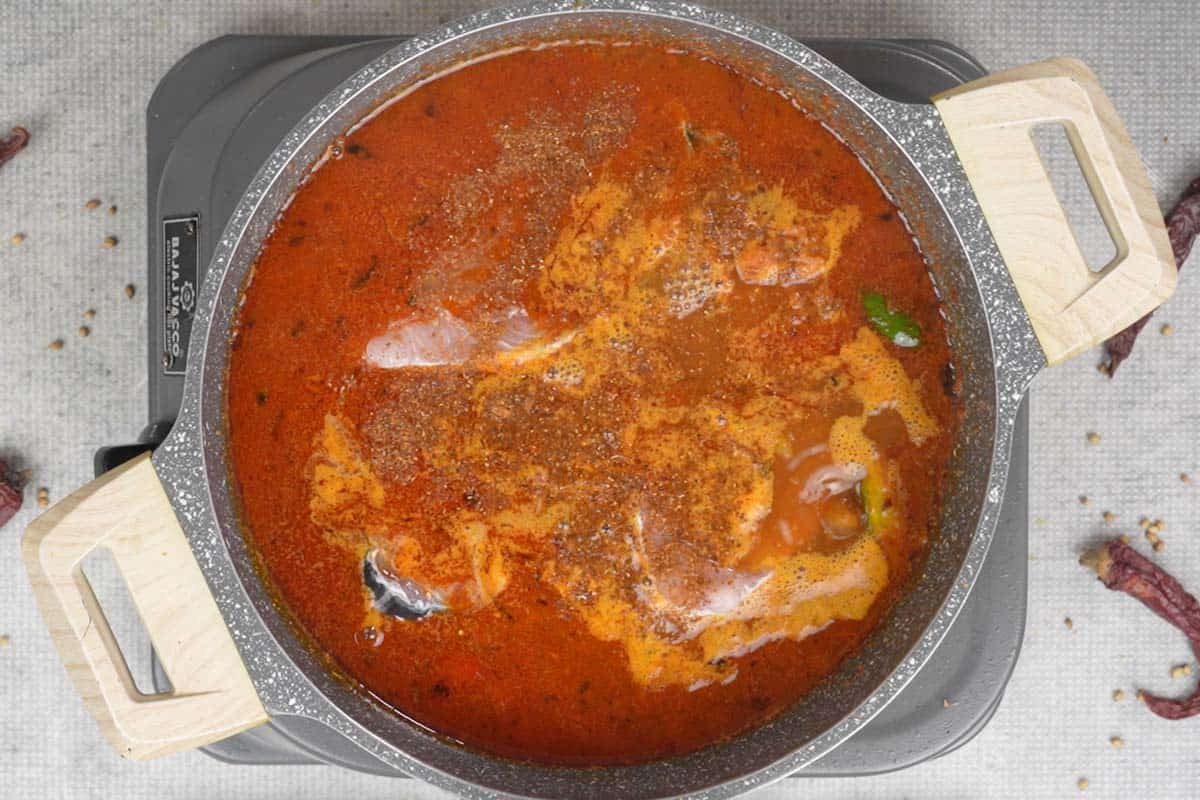 Fish slices and garam masala added to the pan.