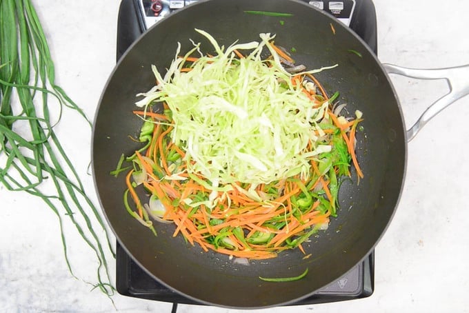 Cabbage added in the pan.