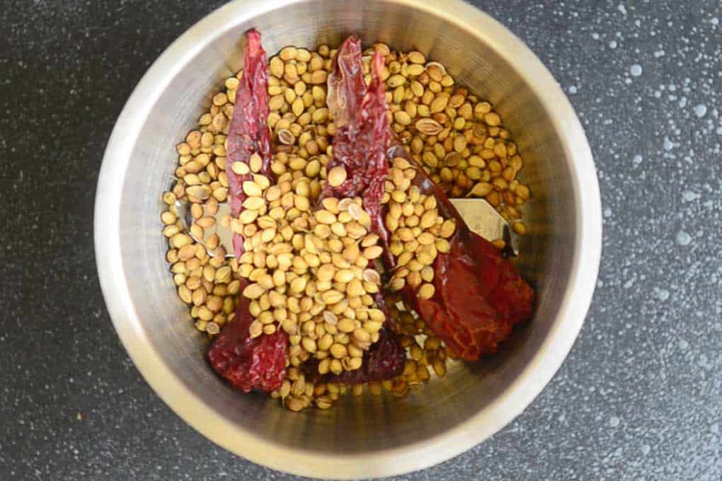 Roasted and cooled dry red chillies and coriander seeds in a blender