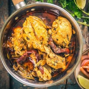 Add all the ingredients for marinating the chicken in a bowl and mix well. Cover the bowl and keep in refrigerator for at least 2 hours. Heat mustard oil in a pan Once the oil is hot, add cloves, black cardamom, bay leaves and dry red chillies. Add onion and fry for 4-5 minutes. Add ginger and garlic and fry for 2 minutes. Add coriander powder and red chilli powder and cook for a few seconds. Add the chicken along with the marinade. Adjust the salt. Cover the pan and cook on medium low heat for 25-30 minutes until the chicken is cooked. Remove the cover and cook for another 3-4 minutes until the gravy is slightly reduced. Add kasuri Methi and cook for another minute. Serve hot with steamed rice.