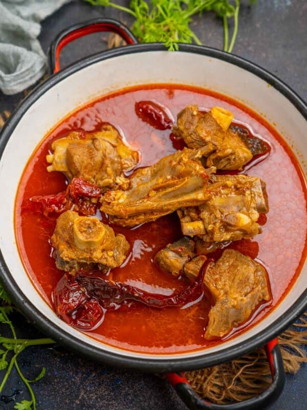 Jungli Maas is a 100-year-old Rajasthani recipe where goat mutton is cooked with just 7 simple ingredients. Serve it with phulka, bajra roti, or makki roti for a traditional meal.