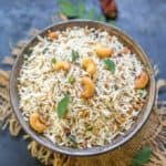 This South Indian Coconut Rice Recipe is a mildly spiced and light rice dish cooked with coconut flakes.