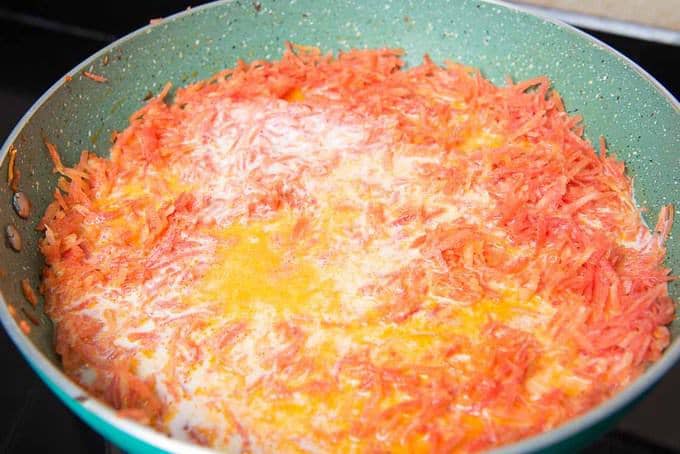 carrot and milk cooking in a pan