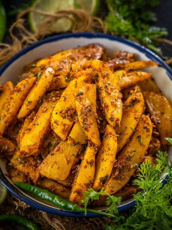 Achari Aloo Masala (Aloo Achari) is a North Indian style potato dish made using Indian pickling spices. It is spicy, and tangy, and can be served with parathas for breakfast or as a side dish with your everyday meals. Here is how to make it (vegan).