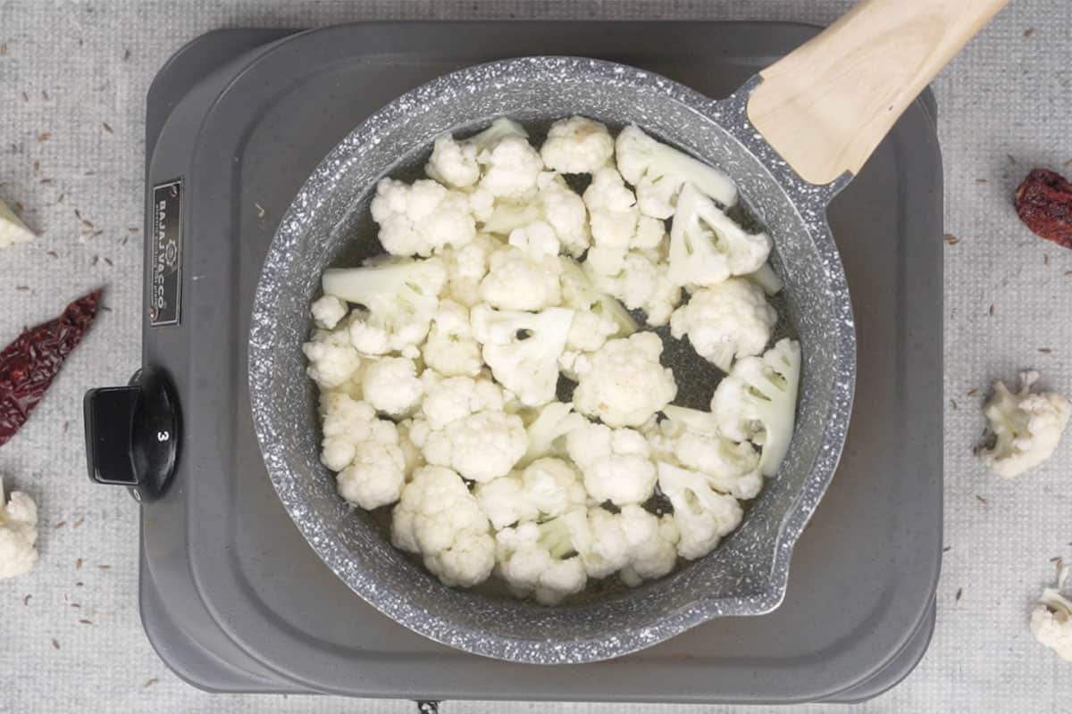Blanching gobhi florets in boiling water.