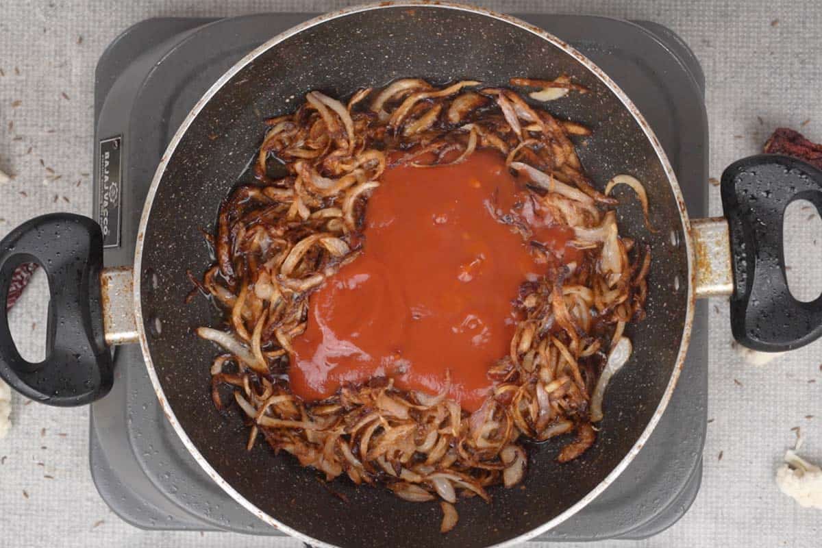 Tomato puree added to the pan.