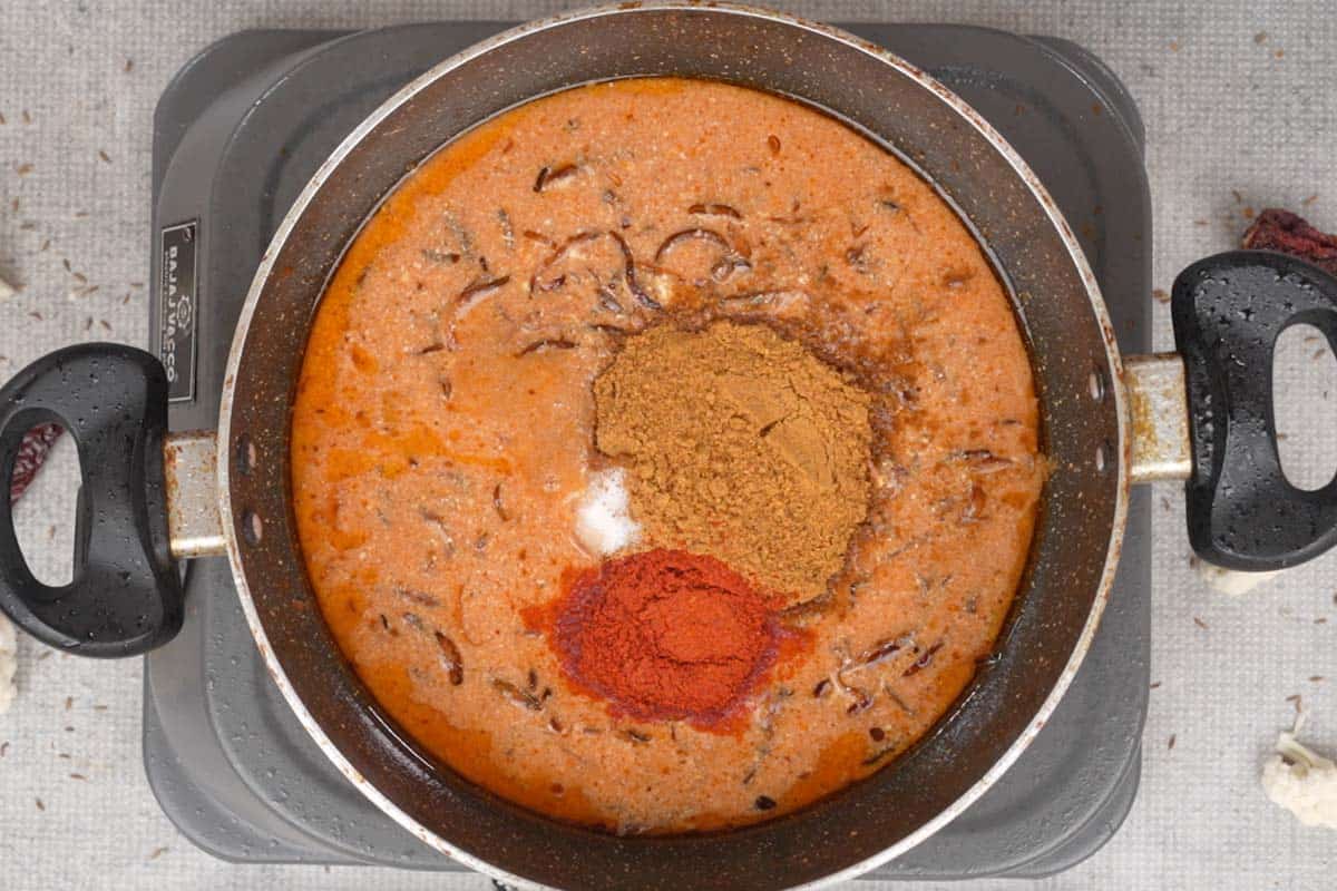 Spice powders added to the pan.