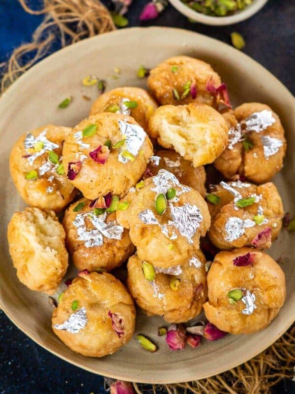 Balushahi (badusha) is a crispy and flaky Indian sweet made using all-purpose flour, ghee, and yogurt. It is popularly made during festivals, weddings, and special occasions. Make it using my tried and tested recipe at home!