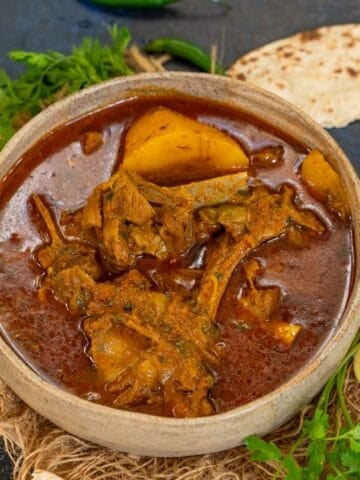 Aloo Gosht (Potato Mutton Curry) is a spicy Indian and Pakistani goat mutton curry. Make it using my easy recipe.