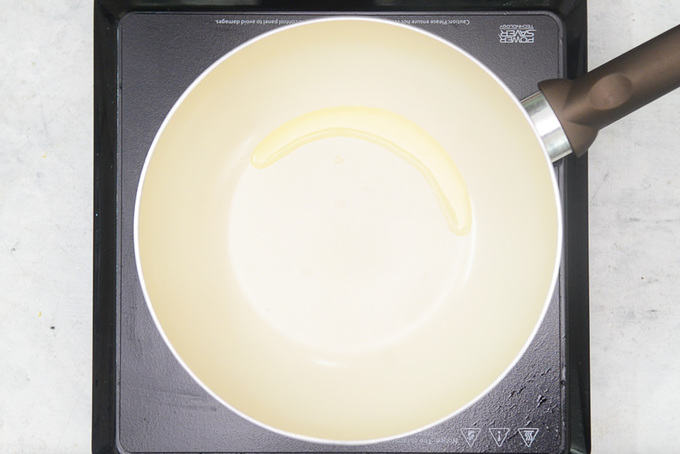 Ghee heating in a pan.