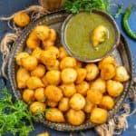 Goli Baje (Mangalore Bajji, Mangalore Bonda) are soft and spongy deep-fried fritters made using all-purpose flour, rice flour, and chickpea flour. Serve them as tea time snack with tea or coffee.
