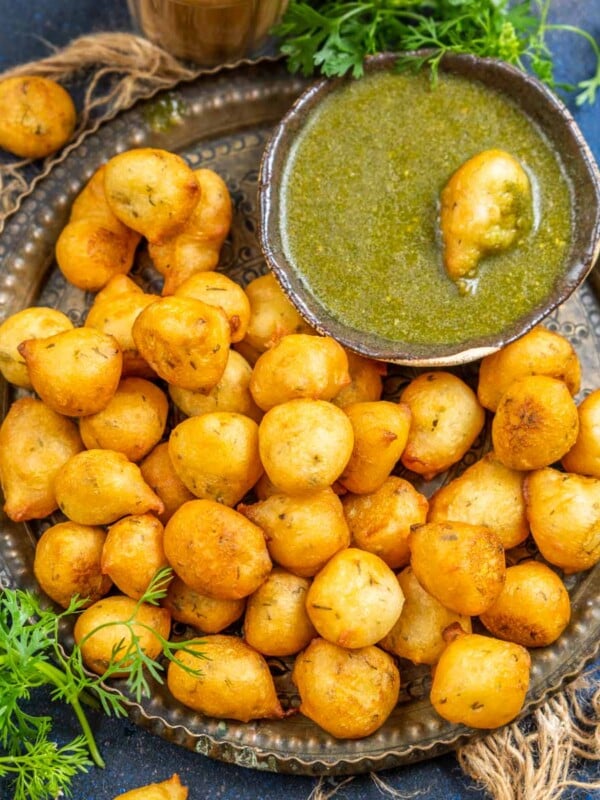 Goli Baje (Mangalore Bajji, Mangalore Bonda) are soft and spongy deep-fried fritters made using all-purpose flour, rice flour, and chickpea flour. Serve them as tea time snack with tea or coffee.