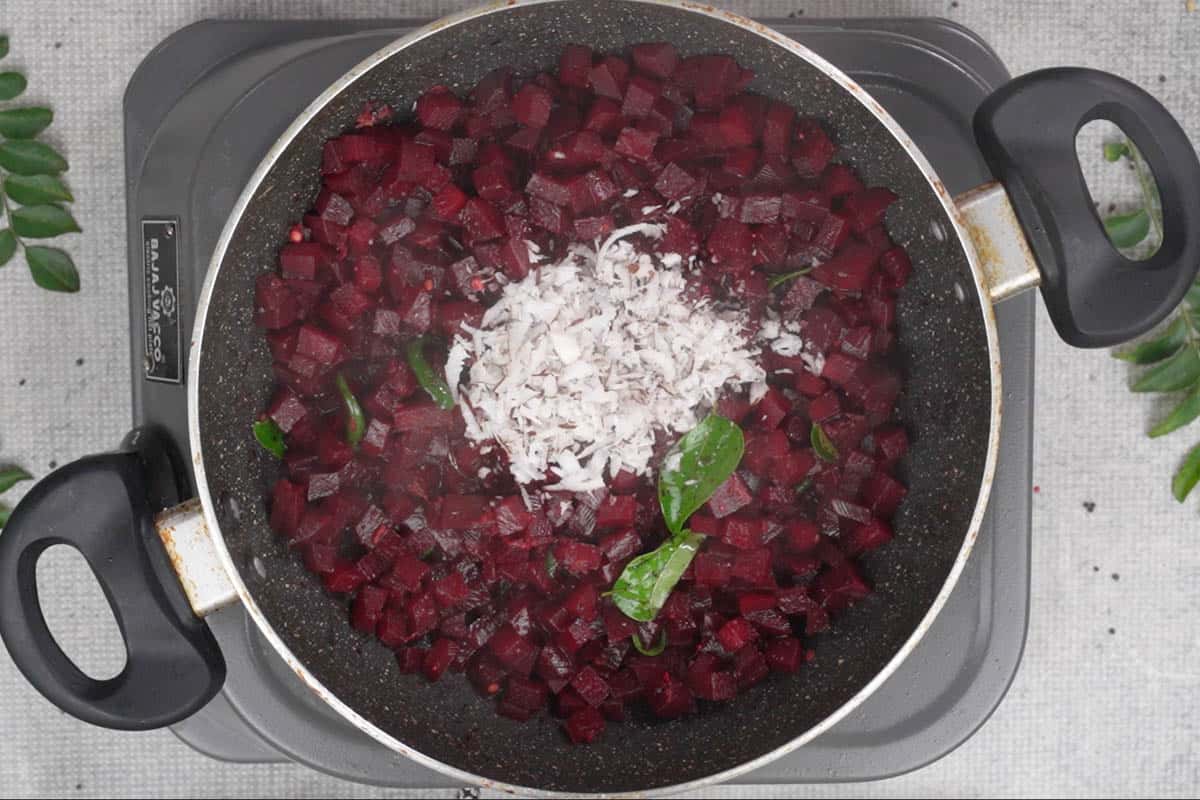 Grated coconut added to the pan.