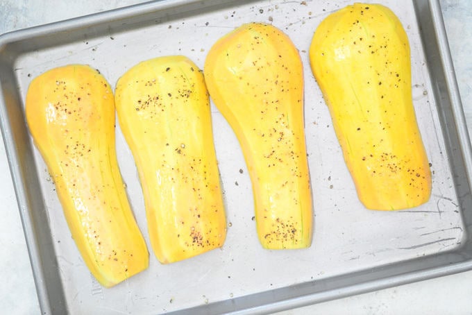 Peeled Butternut Squash Kept on a baking tray and drizzled with oil, salt and pepper.