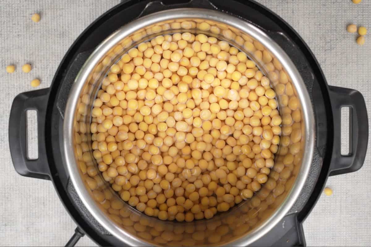 Soaked white peas, water and salt added to an instant pot.