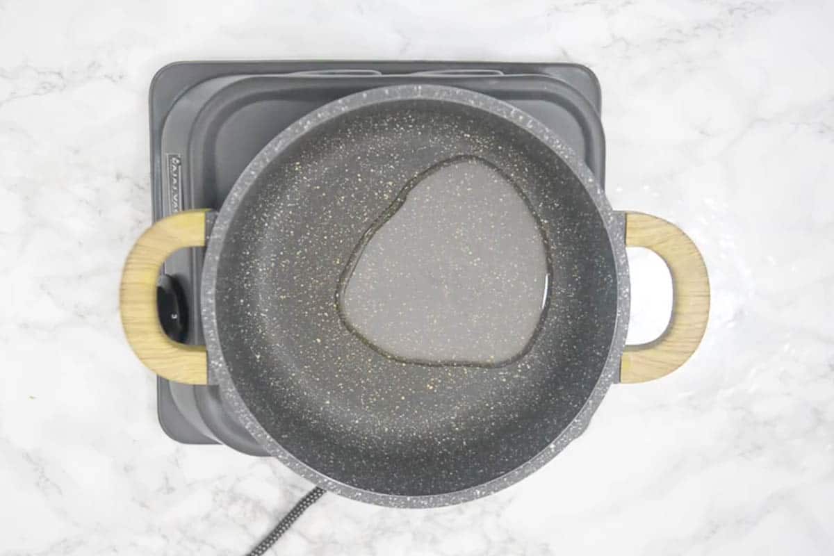 Ghee heating in a pan.
