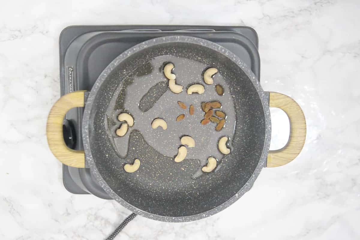 raisins and cashew nuts added to the pan.