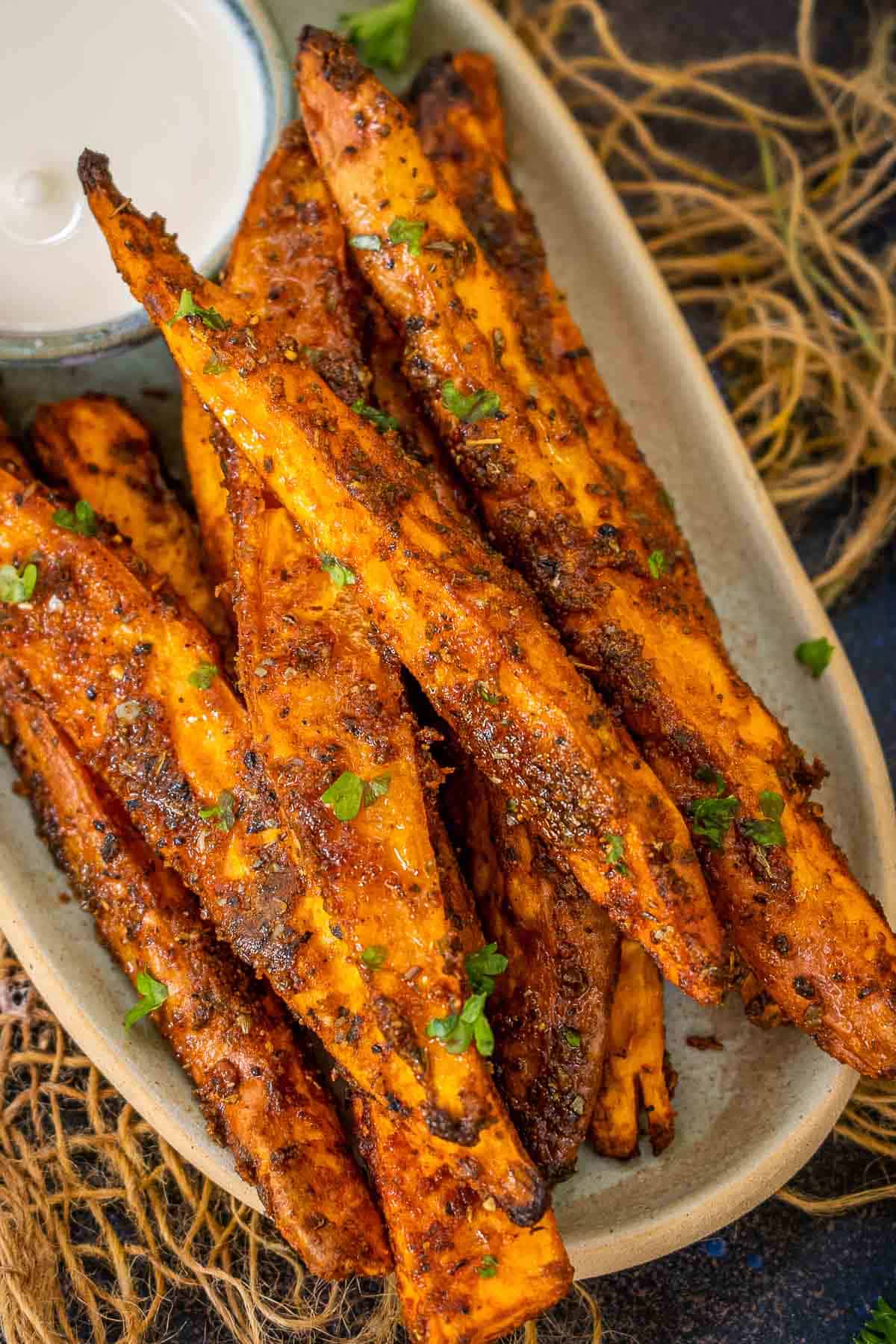 Oven roasted sweet potato wedges served on a plate.