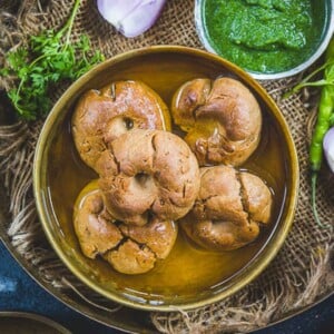 Baati is a traditional Rajasthani bread made using whole wheat flour. It is served with dal, churma, and loads of ghee. Use my easy recipe to make it.