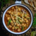 Make this Punjabi Restaurant Style Chana Masala at home using my easy and simple recipe. This recipe gets ready in under 30 minutes and is gluten free too. Just skip curd and ghee to make it vegan as well. Here is how to make Chana Masala Recipe.