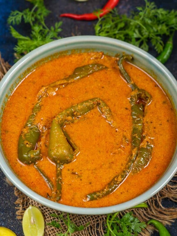 Mirchi Ka Salan is a Hyderabadi-style nutty and spicy curry made using large green chilies. Serve it with biryani or any Indian bread (vegan, gluten-free).