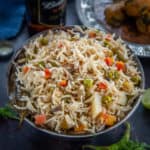 This restaurant-style Veg Pulao is a delicious medley of rice, spices, and vegetables. Also known as Vegetable Pulao Pulav or Indian Pulao, this North Indian dish is very simple and easy to make and pairs perfectly with any raita or curry of your choice.