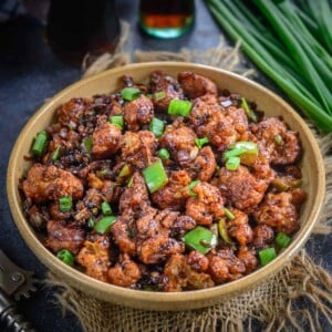 Gobi Manchurian is a popular Indo Chinese dish where crispy fried cauliflower florets are tossed in a spicy sauce. Make it dry and serve as an appetizer or make with gravy for the main course.