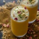 Mango Mastani is a popular Mango Drink sold in Pune. It's basically Mango milkshake topped with ice cream and dry fruits. Here is how to make Mango Mastani Recipe at home.