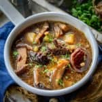 Russian Mushroom Soup is a flavorful soup made using a mix of dried mushroom, barley, and veggies. It is a hearty and filling homestyle soup perfect for winters. Here is how to make it.