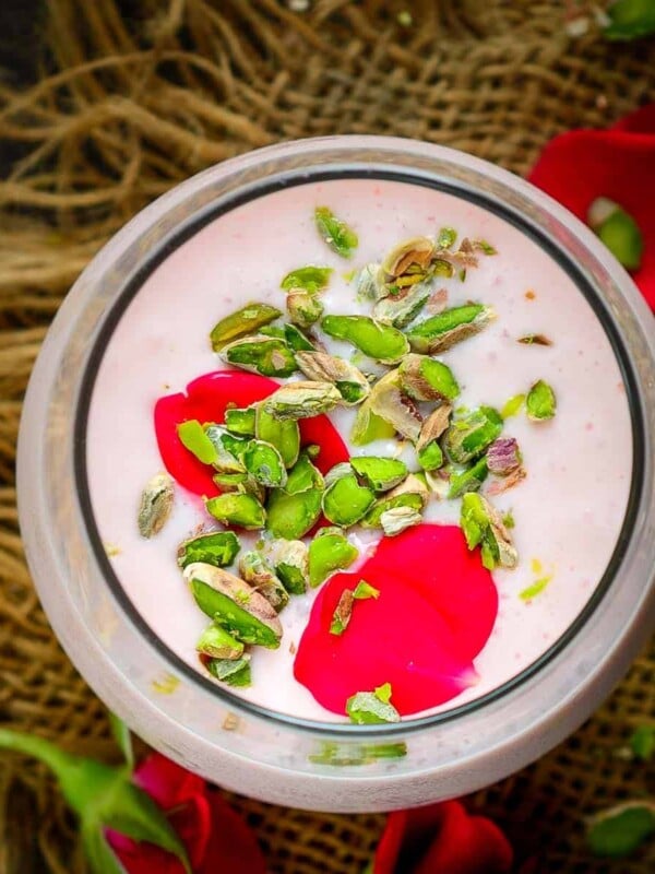 A delicious twist on the traditional lassi, Rose Lassi is flavored with rose syrup, giving it a nice pink hue and refreshing taste. It is a perfect drink for breakfast or an evening snack (vegetarian, gluten-free).