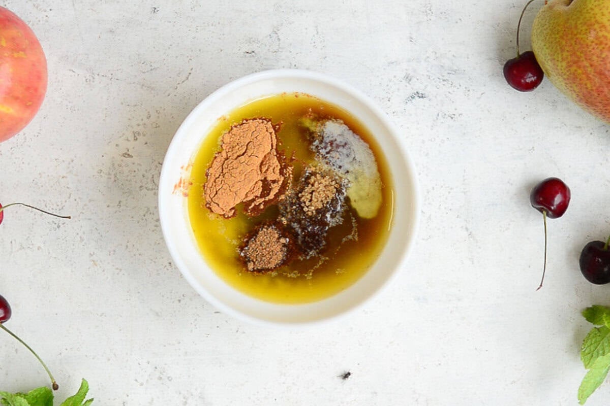 Brown sugar, honey, butter, cinnamon and nutmeg added to a bowl.