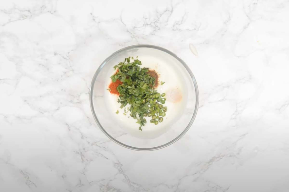 Salt, roasted cumin powder, red chilli powder, fresh coriander, and green chilli added in the bowl.