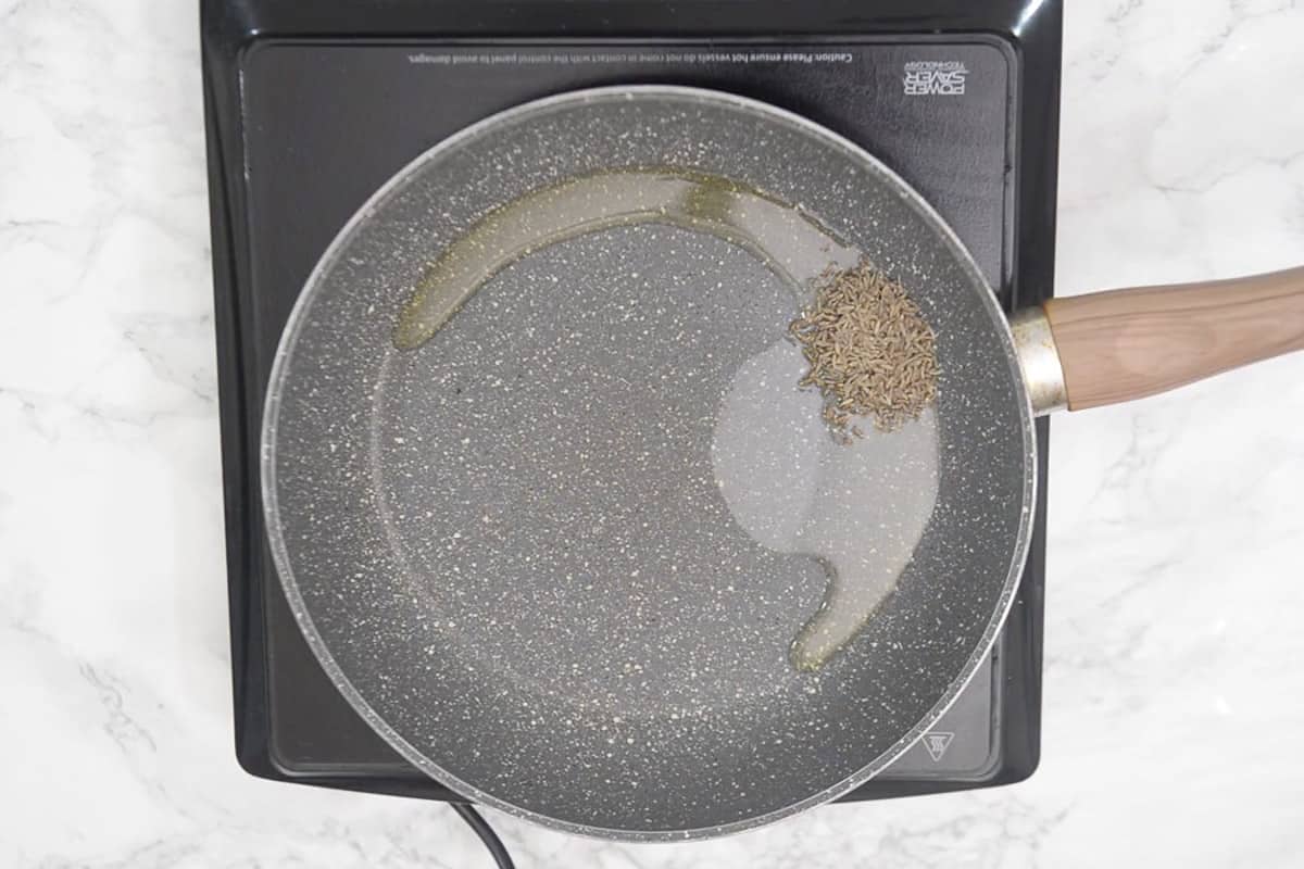 Cumin seeds added in the pan.