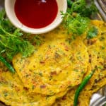 Besan Chilla is an Indian style savory pancake made using chickpea flour. It is also called as veg omelette and is a great dish to serve for breakfast or keep for tiffin box. Here is how to make it.