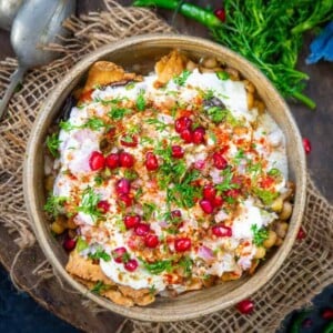 Samosa Chaat is a delicious Indian street food where crispy Punjabi samosa is topped with a tangy and spicy chutney mixture. Here is how to make Samosa Chaat Recipe.