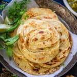 Kerala Parotta or Malabar Parotta is a layered Indian flatbread which goes great with curries. Here is how to make it in a traditional way.